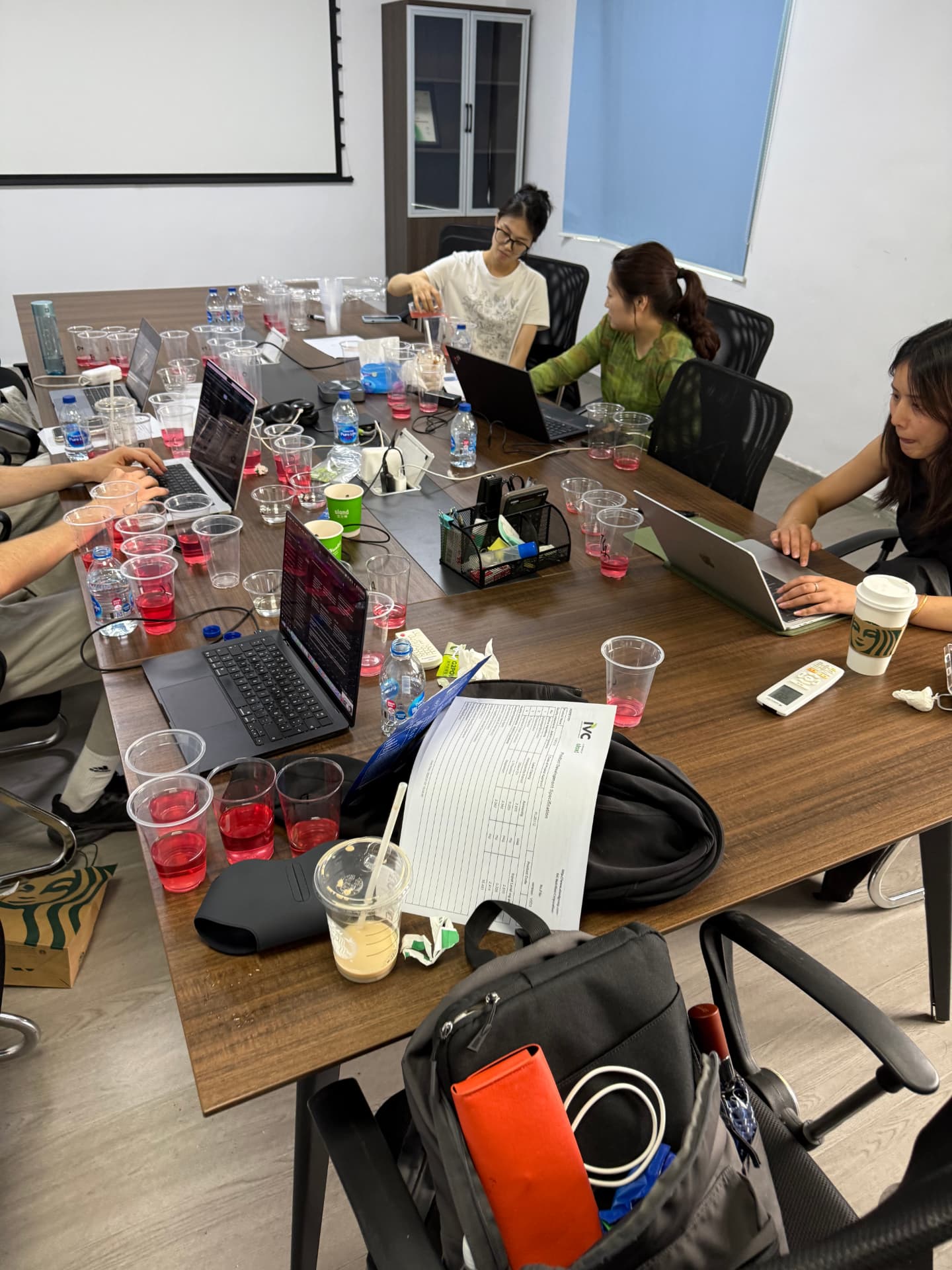 Team tasting session around a meeting-room table in Shanghai