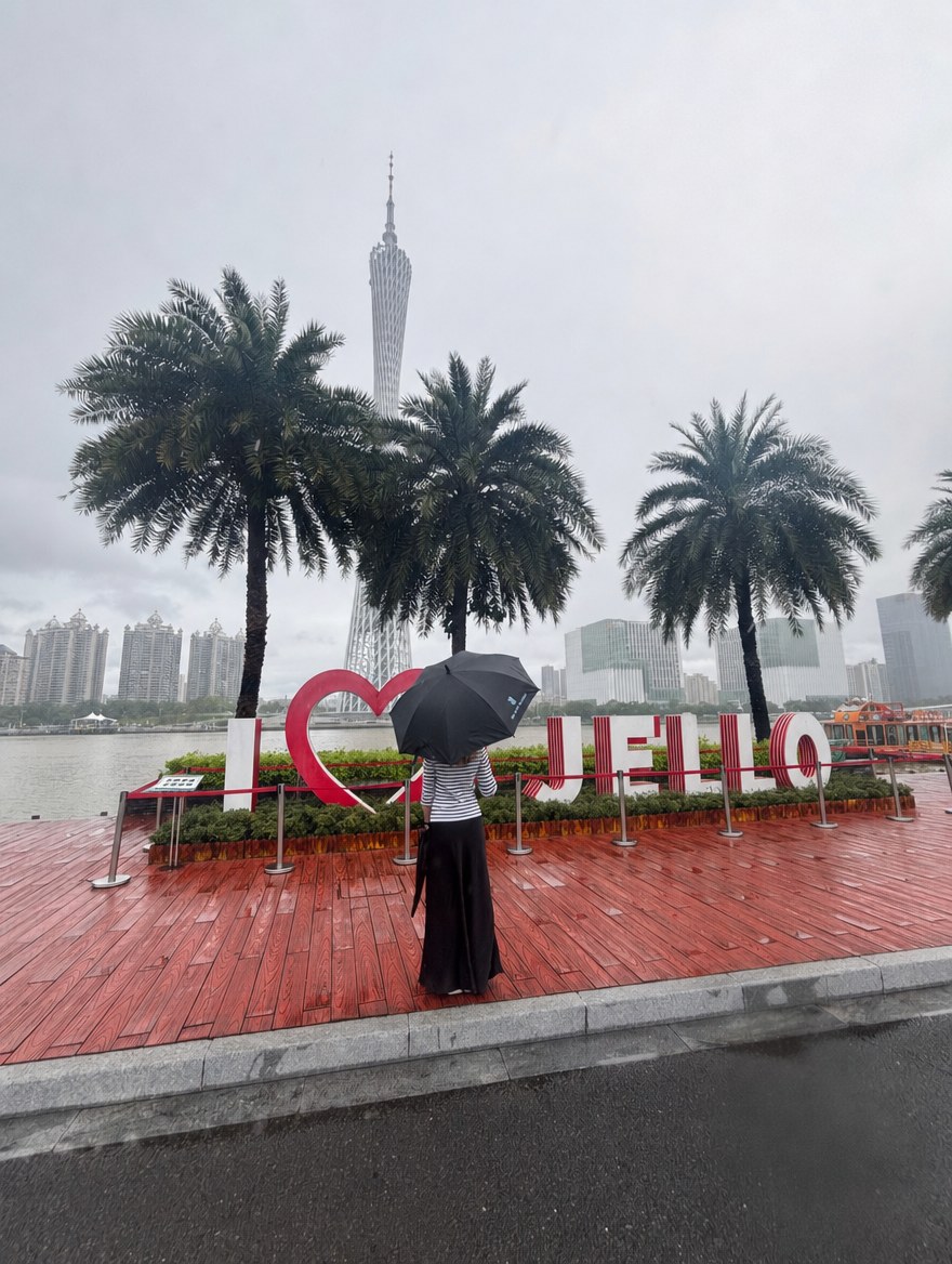 Person with an umbrella in front of an I love Jello sign in Guangzhou